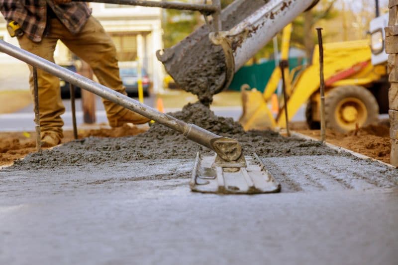 Workers pouring a new concrete driveway